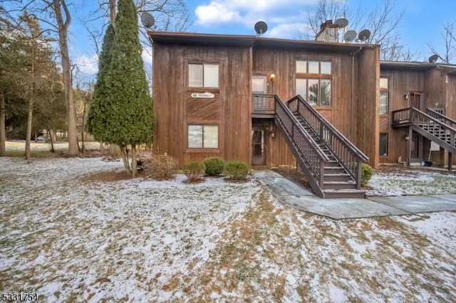 view of snow covered rear of property