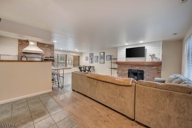 tiled living room featuring a fireplace