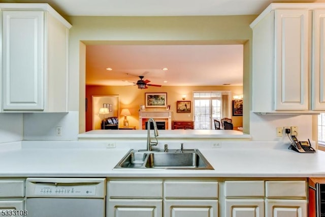 kitchen with ceiling fan, white dishwasher, white cabinets, and sink