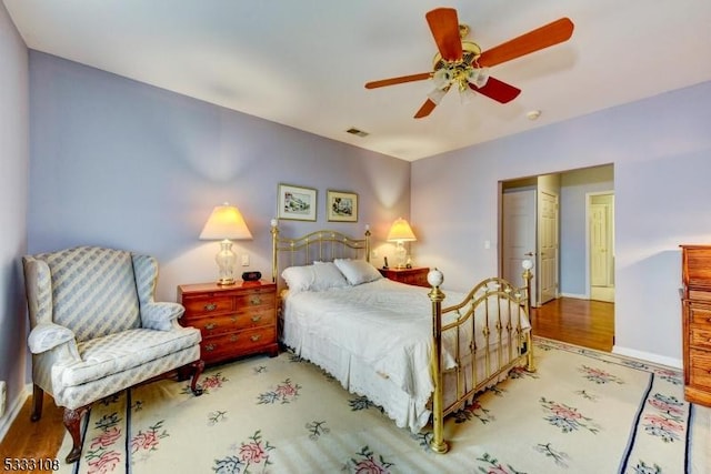 bedroom featuring ceiling fan, a closet, and hardwood / wood-style floors