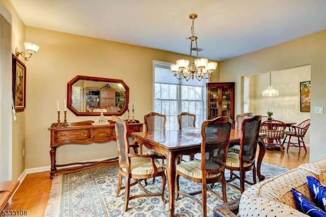 dining area featuring a chandelier and hardwood / wood-style floors