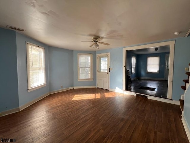 unfurnished living room with ceiling fan and wood-type flooring