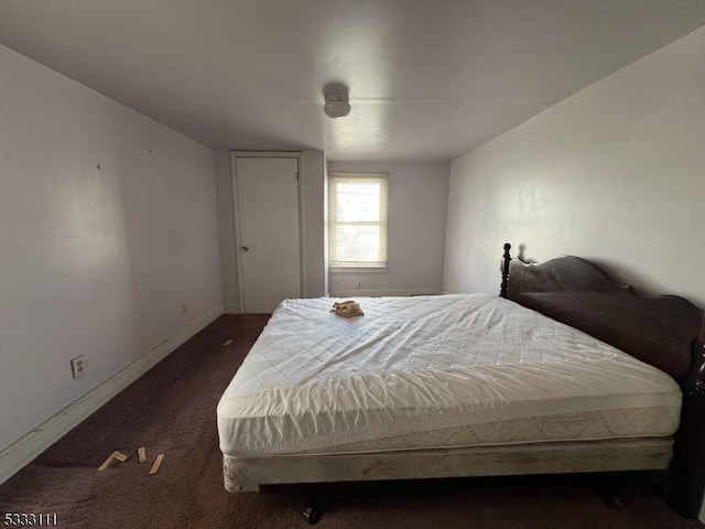 bedroom featuring dark colored carpet