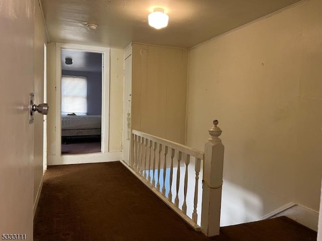 corridor featuring dark colored carpet