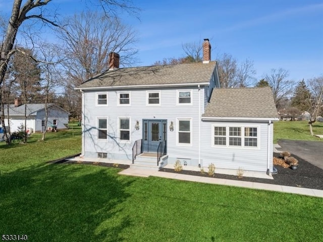 back of house with a lawn