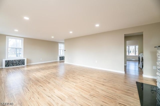 unfurnished living room featuring light wood-type flooring and a fireplace