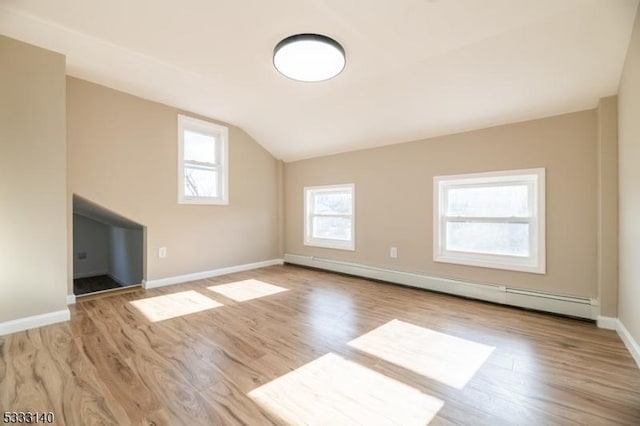 bonus room with baseboard heating, vaulted ceiling, and light hardwood / wood-style floors