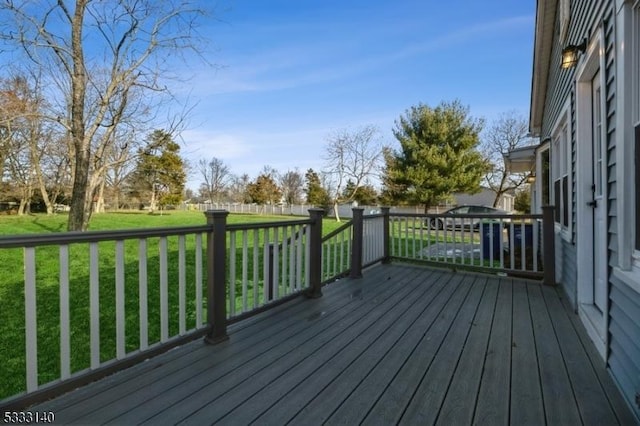 wooden terrace featuring a yard