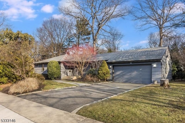 view of front of home with a garage and a front lawn