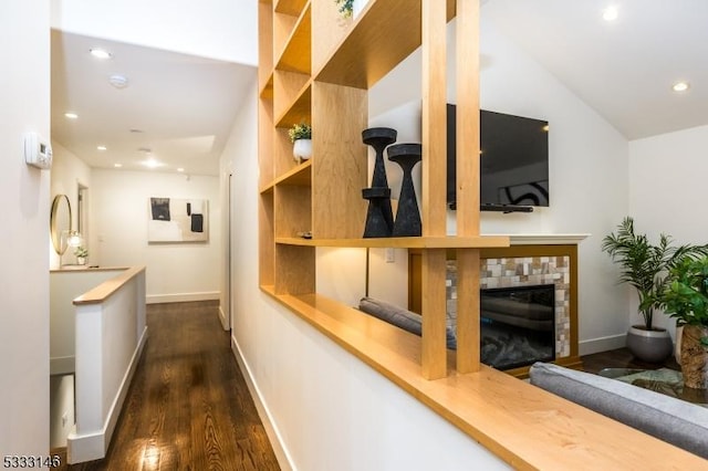 corridor with dark hardwood / wood-style flooring