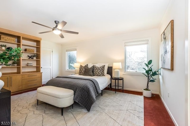 bedroom featuring ceiling fan and multiple windows