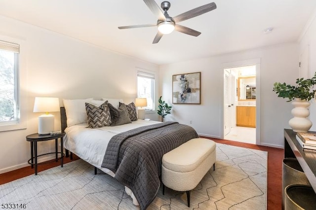 bedroom featuring ceiling fan, light hardwood / wood-style flooring, and ensuite bath