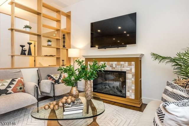 living room featuring a tiled fireplace