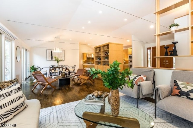 living room with wood-type flooring and vaulted ceiling