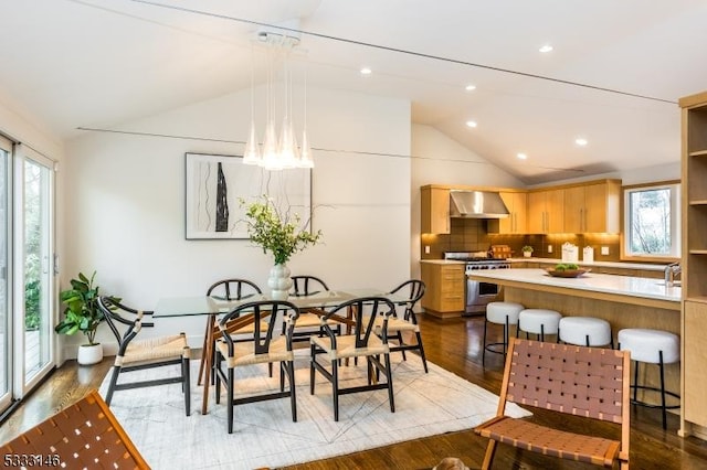 dining space featuring lofted ceiling and light hardwood / wood-style flooring