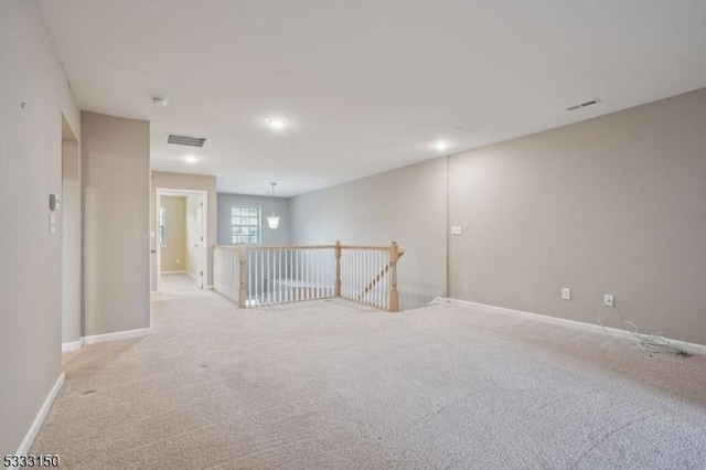 spare room featuring light colored carpet