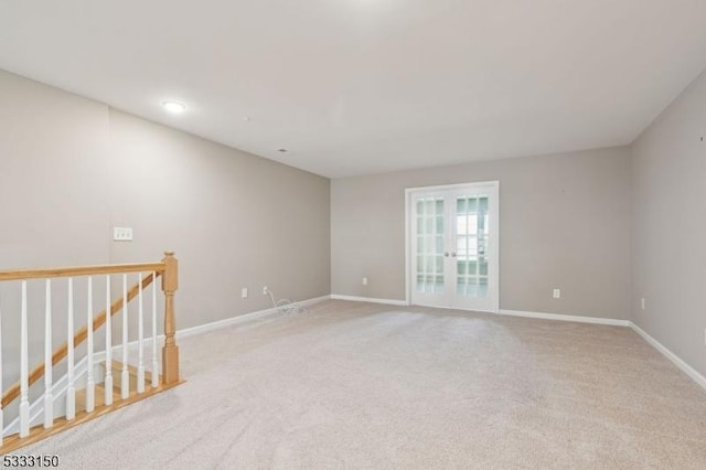 unfurnished room with light carpet and french doors