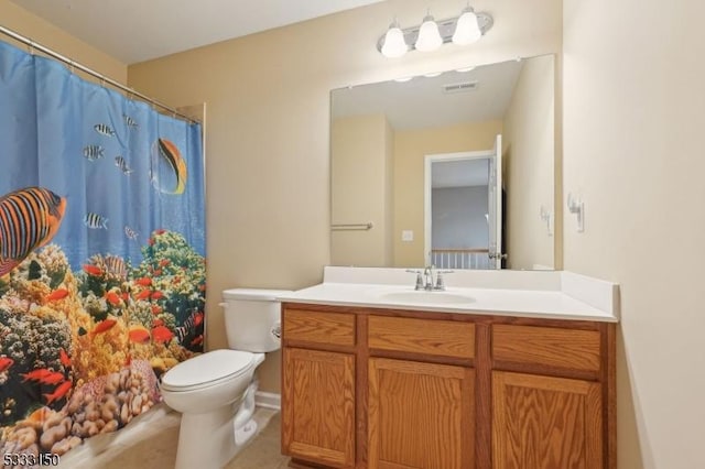 bathroom with tile patterned floors, toilet, and vanity