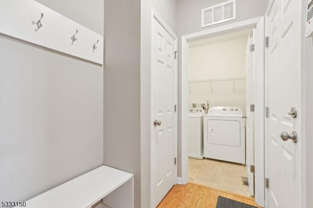 mudroom with washer and dryer and hardwood / wood-style flooring