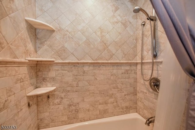 bathroom with shower / bath combo with shower curtain