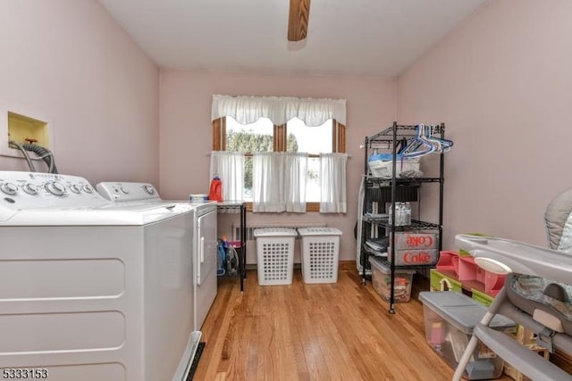 washroom featuring ceiling fan, washer and clothes dryer, and light hardwood / wood-style flooring