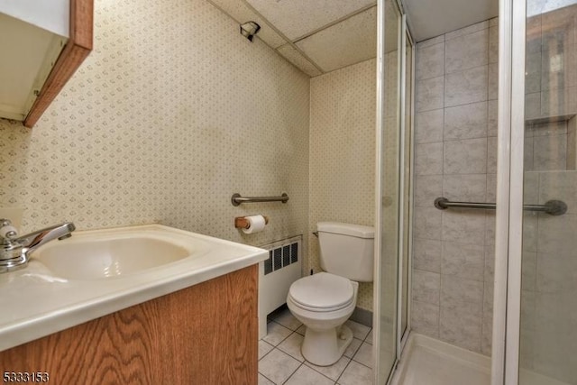 bathroom with an enclosed shower, radiator heating unit, tile patterned floors, vanity, and toilet