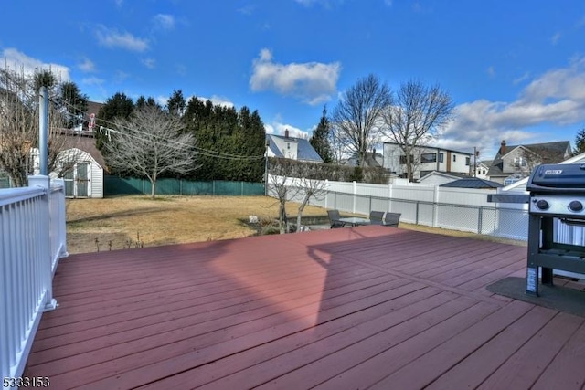 deck featuring a lawn and a shed