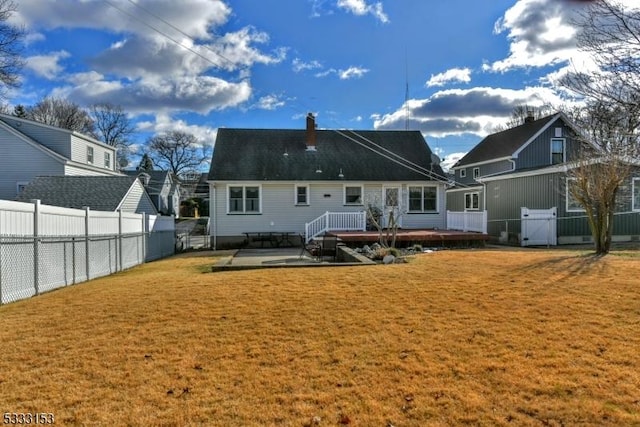 rear view of house with a lawn, a patio area, and a wooden deck