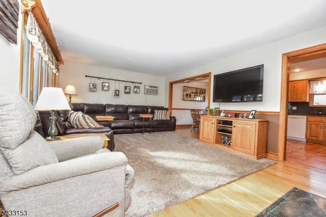 living room featuring a wall mounted AC and hardwood / wood-style floors