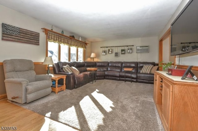 living room featuring hardwood / wood-style floors and a wall unit AC