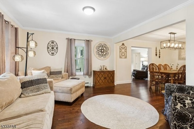 living room with a chandelier, a baseboard heating unit, dark hardwood / wood-style floors, and ornamental molding