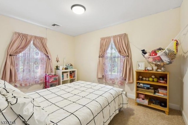 carpeted bedroom with multiple windows