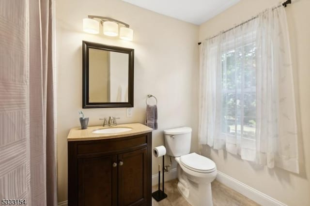 bathroom with toilet and vanity