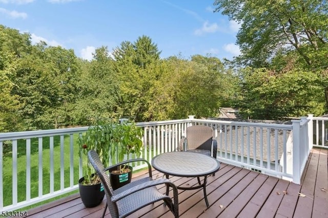 wooden terrace with a yard