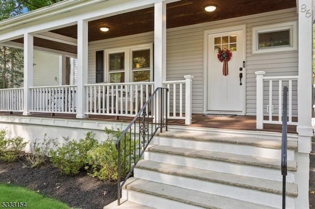 view of exterior entry featuring a porch