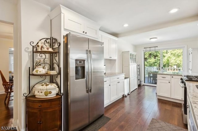 kitchen with light stone countertops, stainless steel fridge, white cabinetry, and dark hardwood / wood-style floors