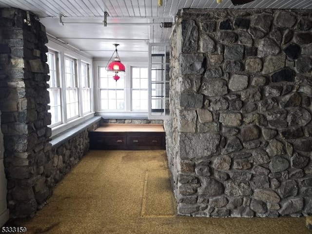 interior space featuring beamed ceiling and carpet flooring