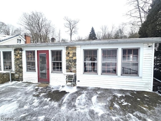 view of snow covered back of property