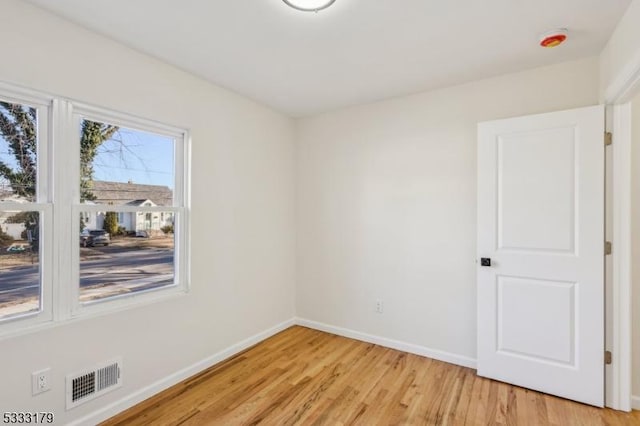 empty room with light hardwood / wood-style floors