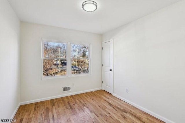 spare room featuring light hardwood / wood-style floors