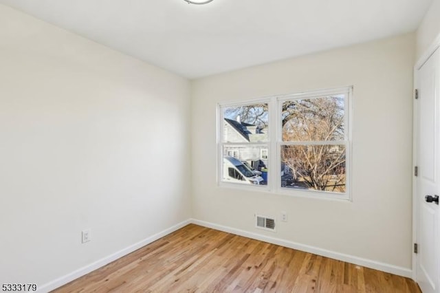 empty room with light hardwood / wood-style floors