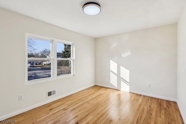 unfurnished room with light hardwood / wood-style floors