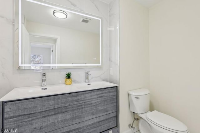 bathroom featuring toilet and vanity