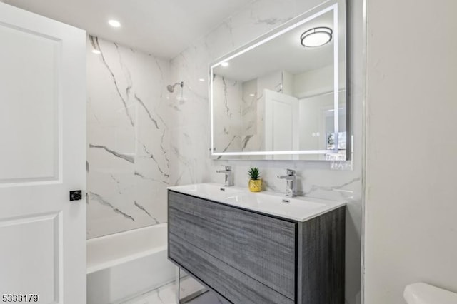 full bathroom with toilet, vanity, and washtub / shower combination