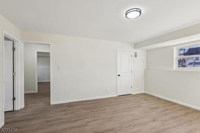 spare room with wood-type flooring