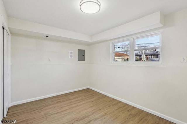 unfurnished room featuring hardwood / wood-style floors and electric panel