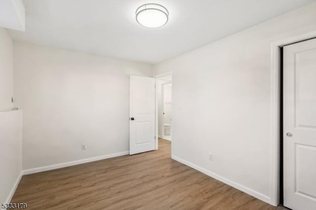 unfurnished bedroom featuring hardwood / wood-style flooring