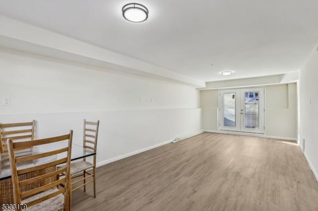 spare room with french doors and hardwood / wood-style flooring