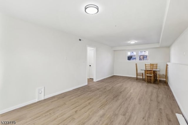 empty room with light hardwood / wood-style flooring