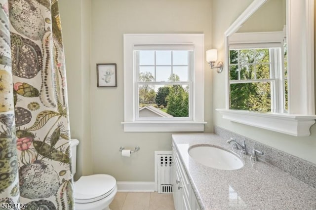 bathroom featuring vanity, toilet, tile patterned floors, radiator heating unit, and baseboards